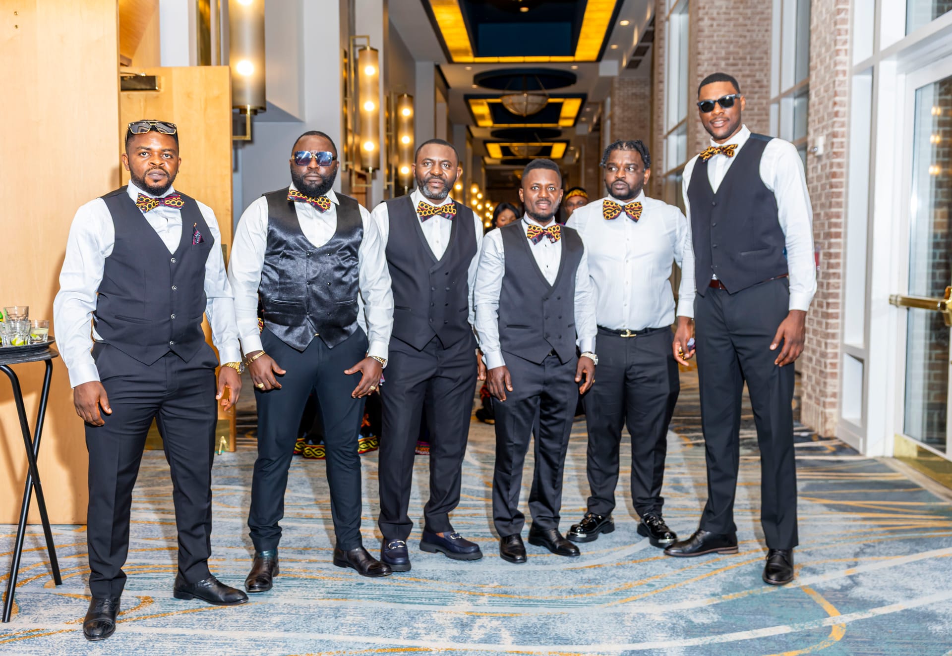 Groomsmen standing together in coordinated formal wedding attire
