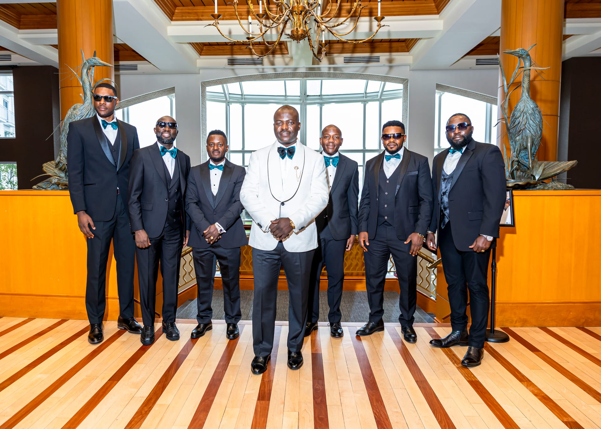 Groom and groomsmen gathered in formal black attire