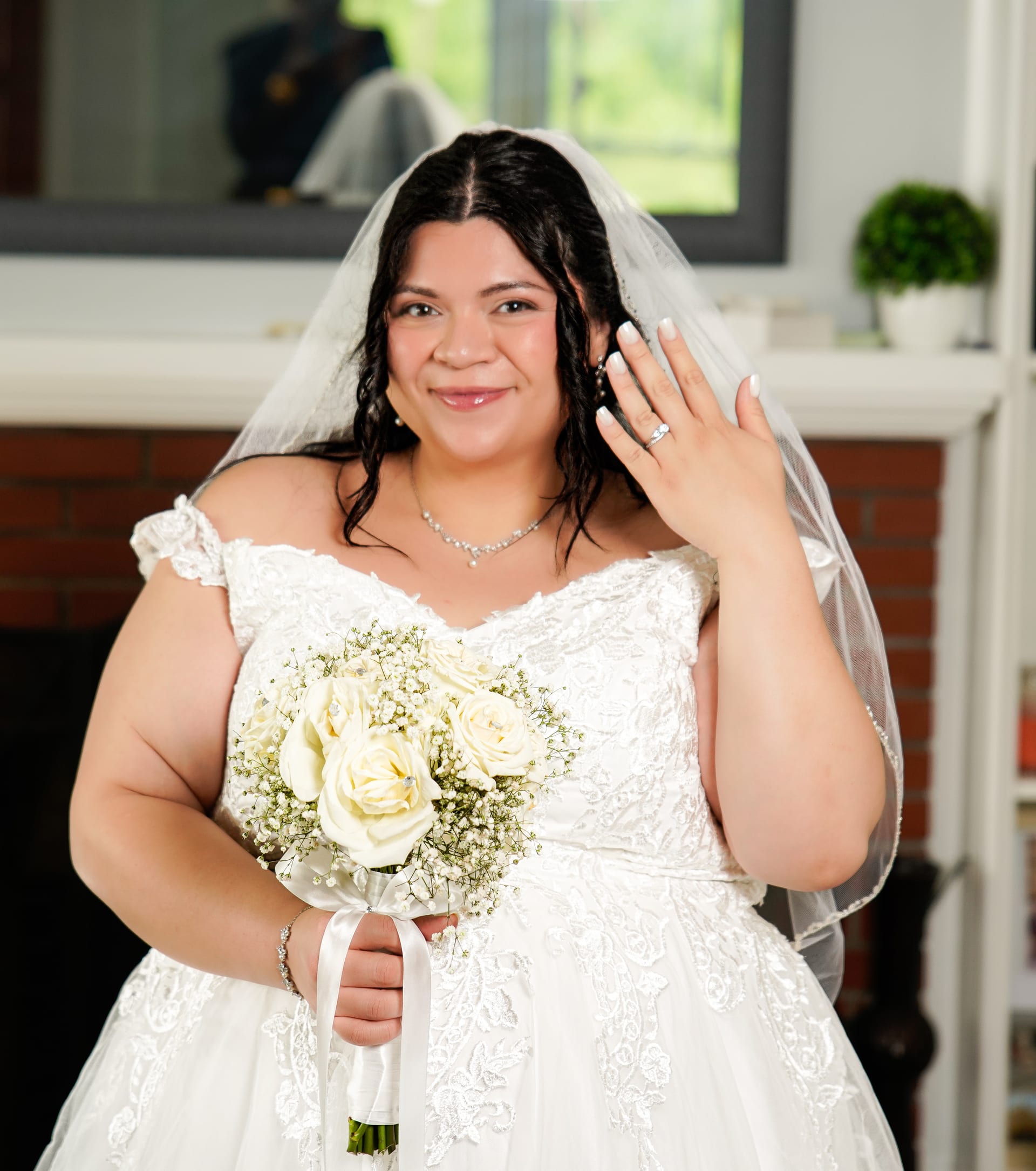 Bride smiling with her bouquet and wedding ring