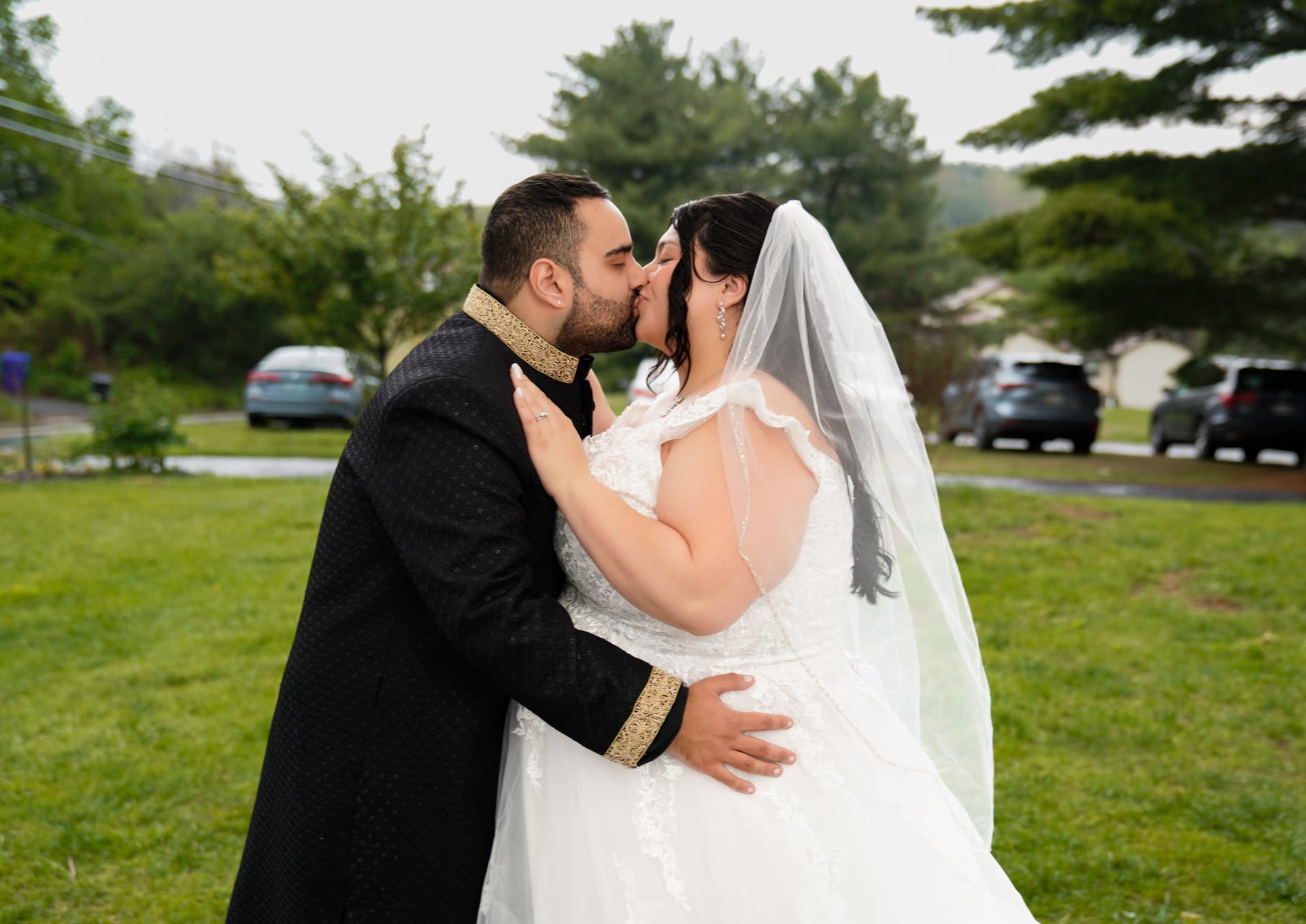 Newly married couple sharing a kiss during outdoor portraits